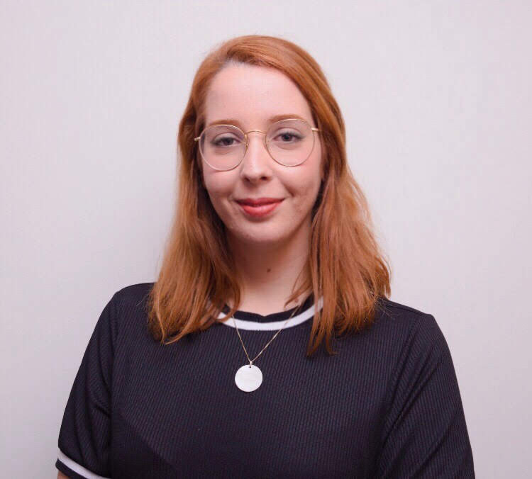 a person with red hair and glasses